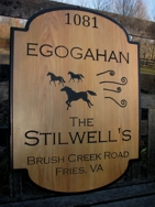 Custom wood sign made of cypress. Black carved lettering.